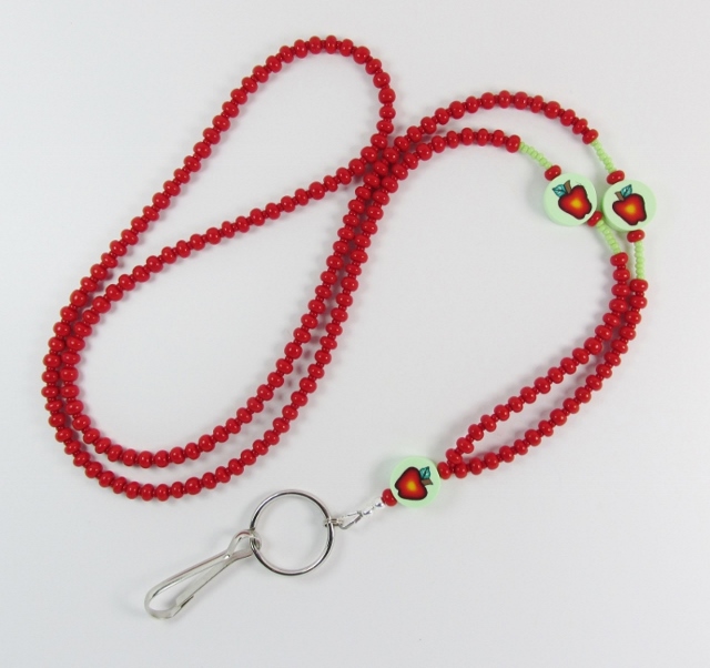 Red and green beaded 
lanyard with polymer apple beads