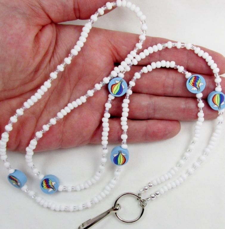 White 
and clear glass beaded lanyard with polymer clay hot air balloon beads