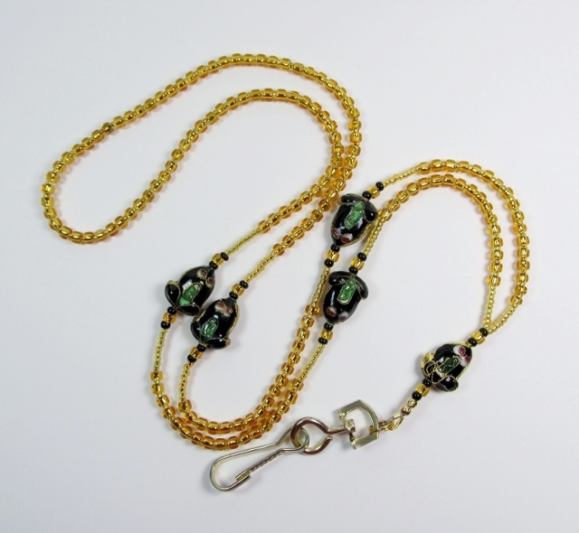 Gold and black 
glass beaded lanyard with cloisonn� black frog beads