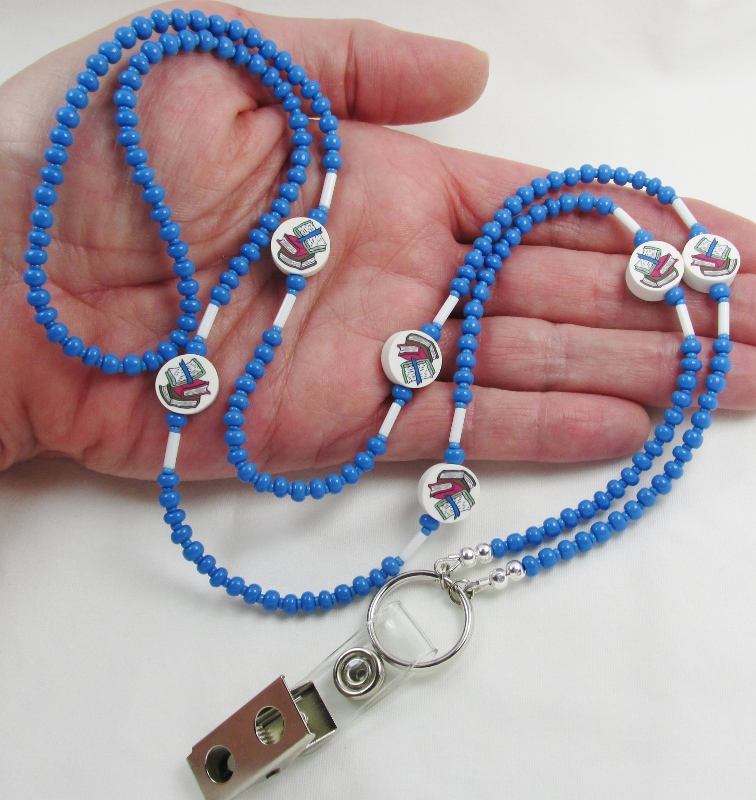 Blue and 
white beaded badge holder necklace with polymer clay books