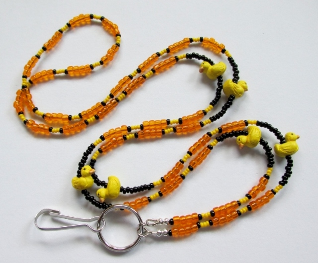 Yellow, orange and 
black glass beaded lanyard with ceramic ducky beads