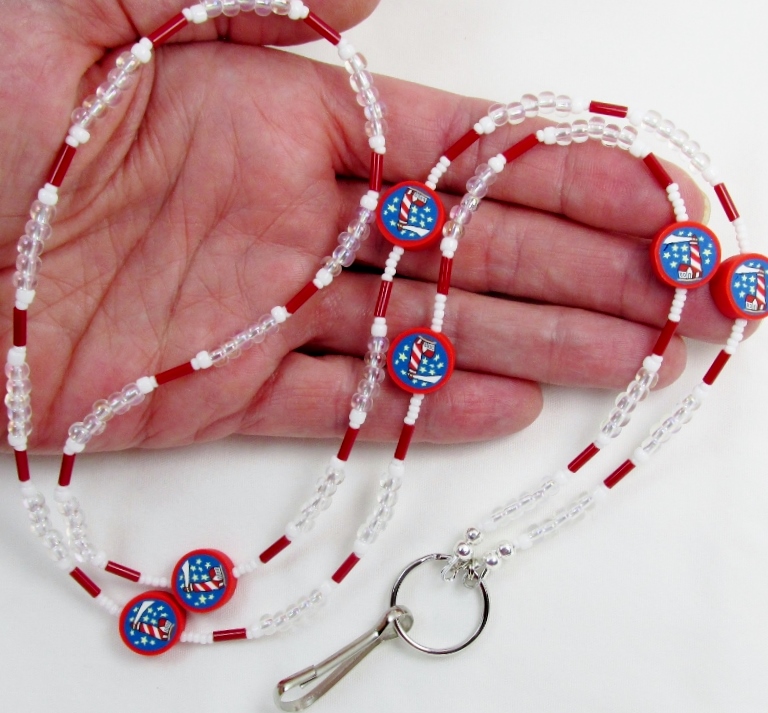 White, red and clear glass beaded lanyard with polymer clay lighthouse beads