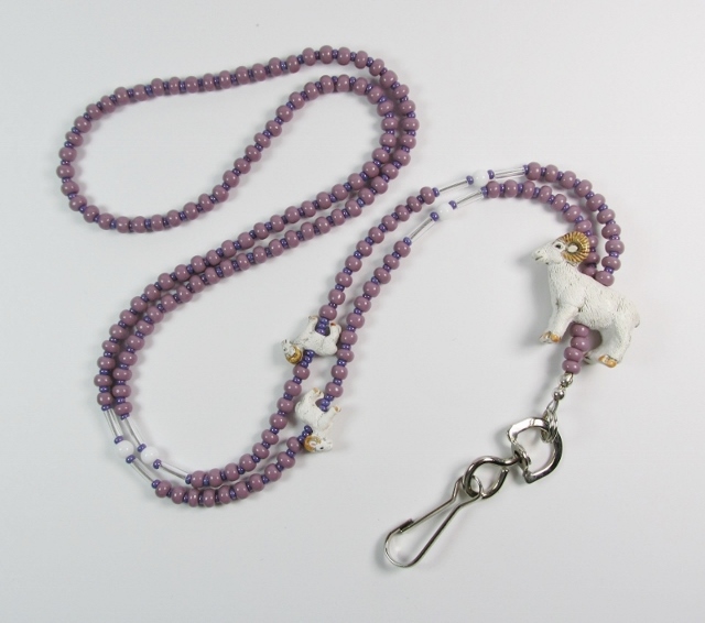 Purple, white and 
clear glass beaded lanyard with ceramic ram beads