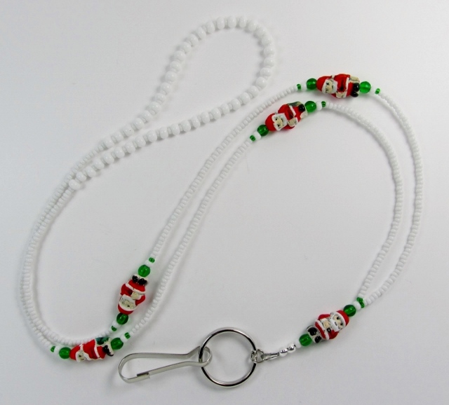 White and green 
glass beaded ID lanyard with Ceramic Santa Beads