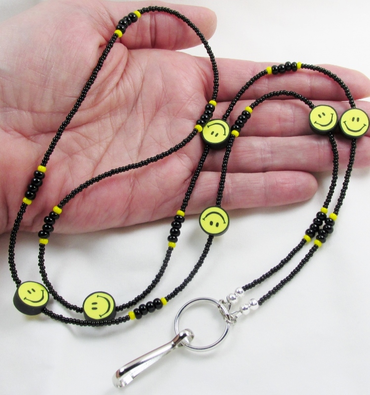 Black and 
yellow glass beaded lanyard with polymer clay smiley face beads