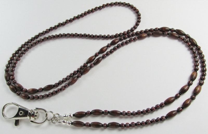 Brown 
wood and glass beaded lanyard