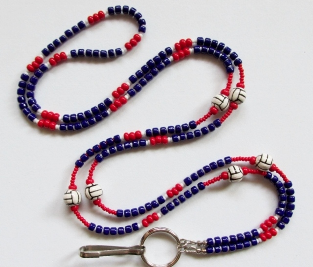 Red, white and 
blue beaded lanyard with ceramic volleyballs